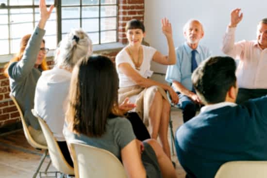 People raising hands to ask